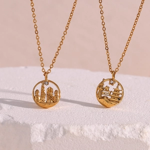 Golden stainless steel necklaces with world city landmarks and sparkling rhinestones