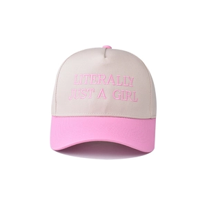 Close-up of pink 'LITERALLY JUST A GIRL' embroidery on beige cotton baseball cap