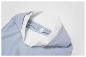 Detail of high-elasticity light blue yoga set with white ribbed knit and precise stitching