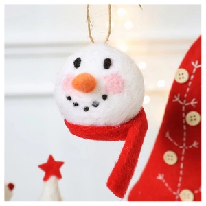 Close-up of a handmade wool felt snowman ornament with a red scarf and rustic hemp rope