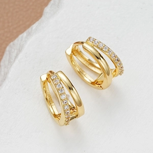 Detail of gold double-hoop earrings featuring sparkling cubic zirconia pavé setting