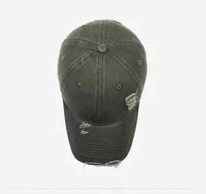 Close-up of vintage olive green denim baseball cap with NAB NARA embroidery and distressed edges