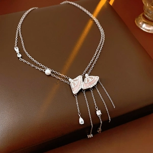 Detail of silver fan pendant necklace with pink acetate, pearls and sparkling zircons