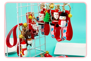 Detail of Christmas PVC keychains with Santa and Reindeer on red silicone straps