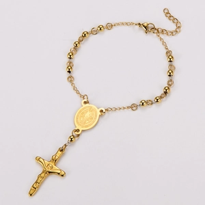 Close-up of gold 18k plated stainless steel rosary bracelet with crucifix and saint medal