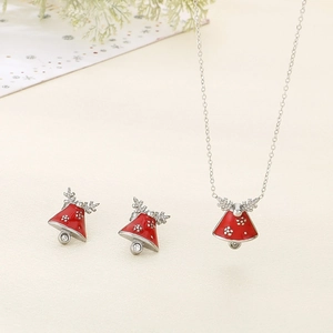 Detailed view of red Christmas bell jewelry set with reindeer antlers and festive motifs