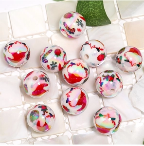 Detailed view of clear acrylic beads with colorful Santa Claus and candy cane prints