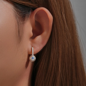 Close-up of s925 silver star earring with blue evil eye stone and elegant pearl drop