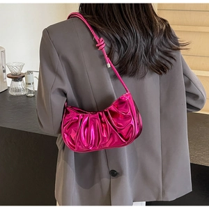 Metallic pink pleated underarm bag with glossy mirror finish and knotted strap detail