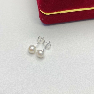 Close-up of natural white freshwater pearl studs with S925 sterling silver butterfly backs