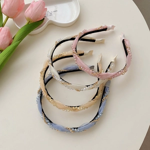 Detail of woven fabric headbands with pearl chains and crystals in four colors