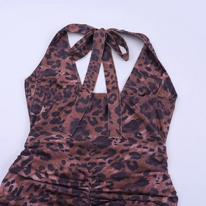 Close-up of leopard print halter neck design with elegant ruched detail on mini dress