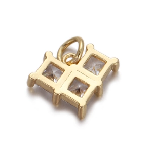 Detail view of gold-plated cross pendant with clear cubic zirconia stones on white background