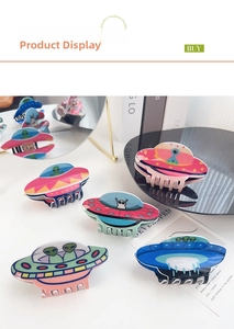 Detailed view of five colorful UFO alien hair claws made of glossy acrylic material
