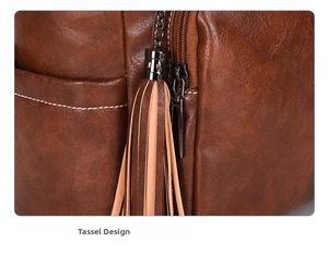 Close-up of vintage brown leather backpack with two-tone tassels and white contrast stitching