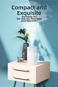 Close-up of compact white USB humidifier spraying mist on a modern bedside table