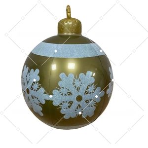 Detail view of inflatable golden Christmas ball with white snowflake patterns and top ring