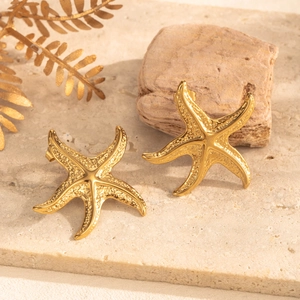 Golden starfish stud earrings in stainless steel with textured finish on stone base
