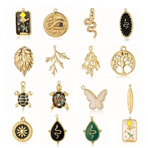 Golden pendant set with snake, floral, and leaf designs in colorful enamel and gems