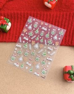 Christmas nail stickers with gold gingerbread man and snowflake patterns on model YT4441