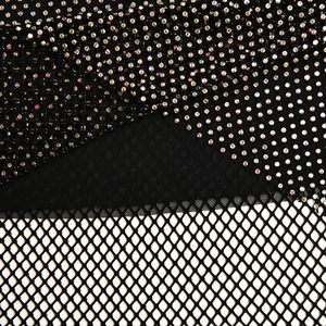 Macro shot of shimmering colorful rhinestones on black mesh fabric detail