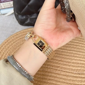 Elegant gold padlock watch for women with black square dial and metal chain strap on wrist