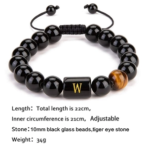 Adjustable tiger eye and black bead bracelet with gold letter W charm on black woven cord