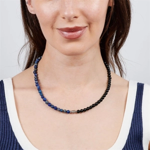 Close-up detail of a 6mm lapis lazuli and black obsidian beaded necklace on a model