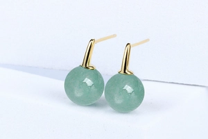 Close-up of S925 silver stud earrings with light green aventurine beads on white stand