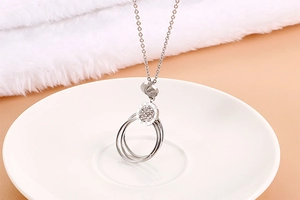 Detail of silver stainless steel necklace with roman numerals and inlaid crystals