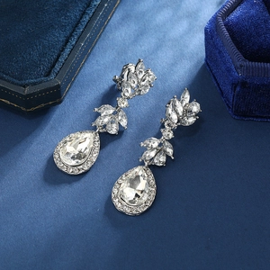 Luxurious silver drop earrings with marquise and teardrop rhinestones on blue velvet boxes
