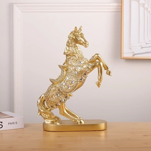 Elegant gold resin horse sculpture with blue gemstone accents on a premium wooden table