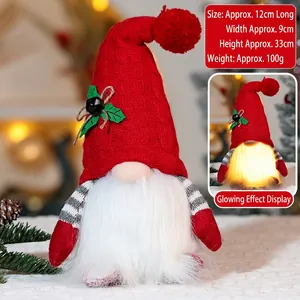 Close-up of glowing Christmas Rudolph gnome with red knitted hat and warm light detail