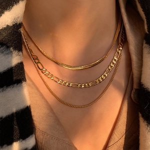 Three-layer gold Figaro and snake chain necklace set for women on model