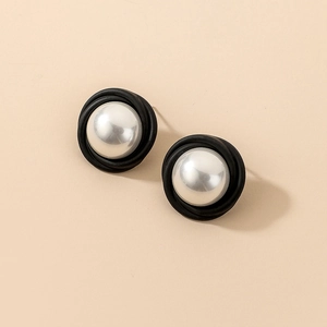 Détail de boucles d'oreilles rondes vintage avec perles argentées et bordure noire