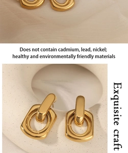 Detailed close-up of gold interlocking geometric earrings on white ceramic base