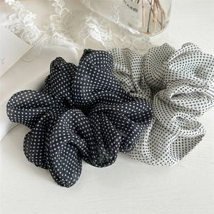 Detail of mesh polka dot scrunchies in black and white with high elasticity and soft texture
