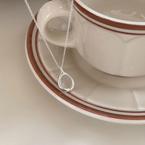 Minimalist 925 sterling silver teardrop necklace with organic texture on vintage background