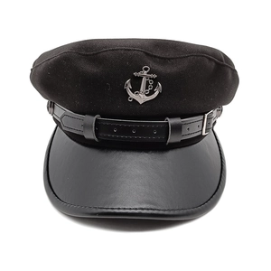Detail of black wool sailor cap with faux leather brim and silver anchor badge