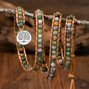 Handmade Indian Agate wrap bracelet with Tree of Life charm on natural wood background