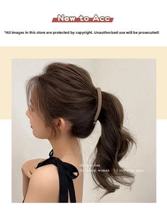 Side view of matte brown banana hair clip holding a ponytail on a female model