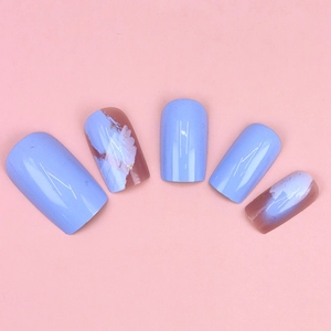 Detail of lavender press-on nails with artistic ink marble texture and gold foil flakes