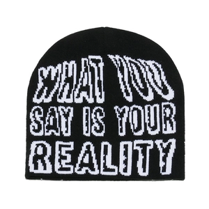 Black knit beanie with WHAT YOU SAY IS YOUR REALITY text print for winter warmth