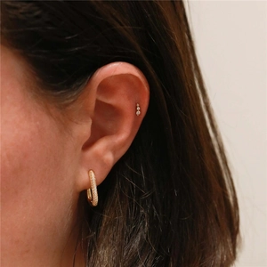 Close-up of S925 silver gold hoop with pavé diamonds and matching geometric cartilage stud