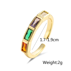 Detailed shot of gold adjustable ring with four color zircon stones and 2g weight mark