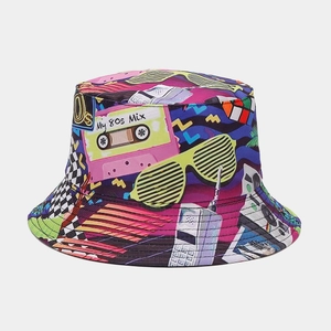 Detail of 80s retro graffiti print bucket hat featuring vintage cassettes and mobile phones