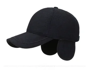 Detail view of winter baseball cap with earflaps and silver metal M logo