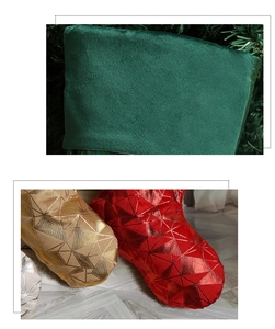 Detail of dark green velvet Christmas stockings with golden geometric textured patterns