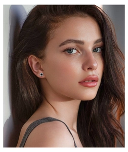 Fashionable S925 silver stud earrings with black moissanite stone on a female model