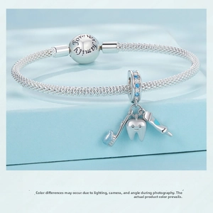 Detailed close-up of S925 silver mesh bracelet with dental charms and Forever Family clasp